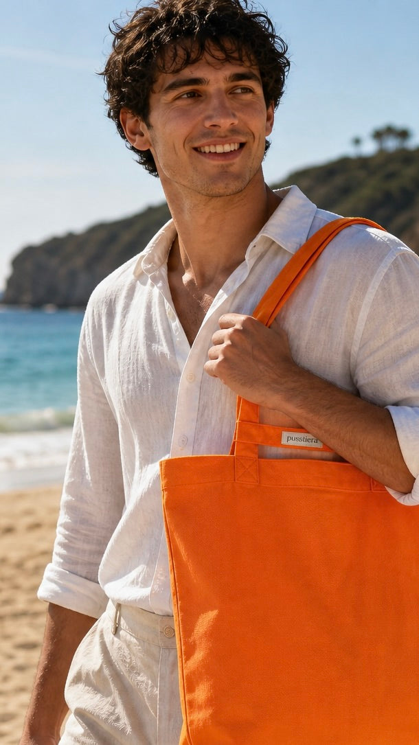 Man wearing an orange  tote bag on a beach