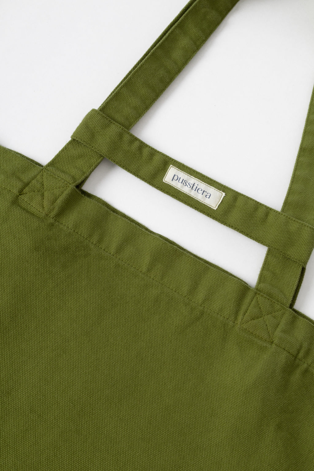 pusstiera tote bag An elegant sustainable cotton canvas tote bag, eco-friendly, premium Swedish design with Scandinavian quality, made in Europe, in limited edition numbered bags. Avocado color with four utility loops and a stabilizing strap