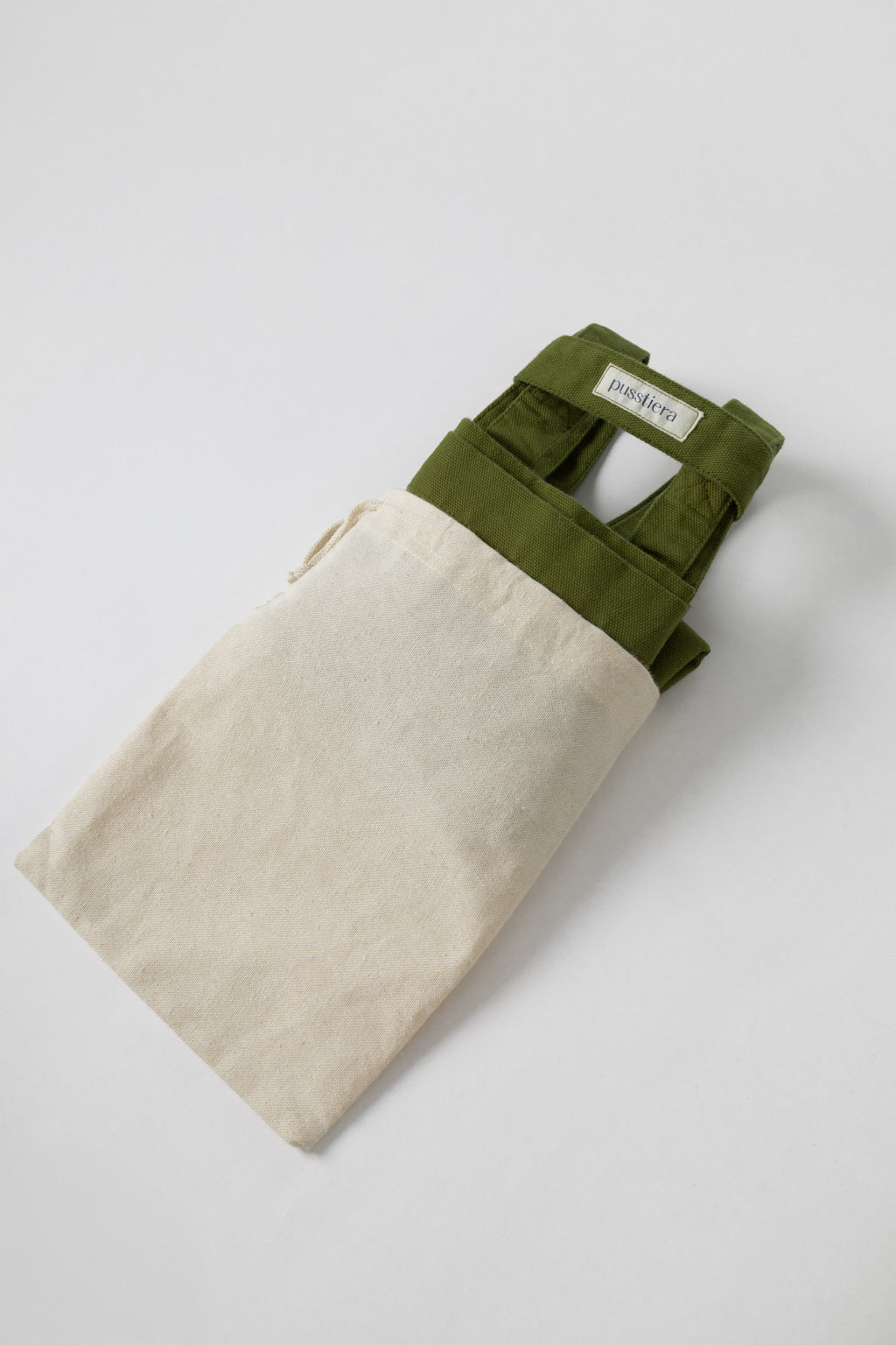 pusstiera tote bag An elegant sustainable cotton canvas tote bag, eco-friendly, premium Swedish design with Scandinavian quality, made in Europe, in limited edition numbered bags. Avocado color with four utility loops and a stabilizing strap