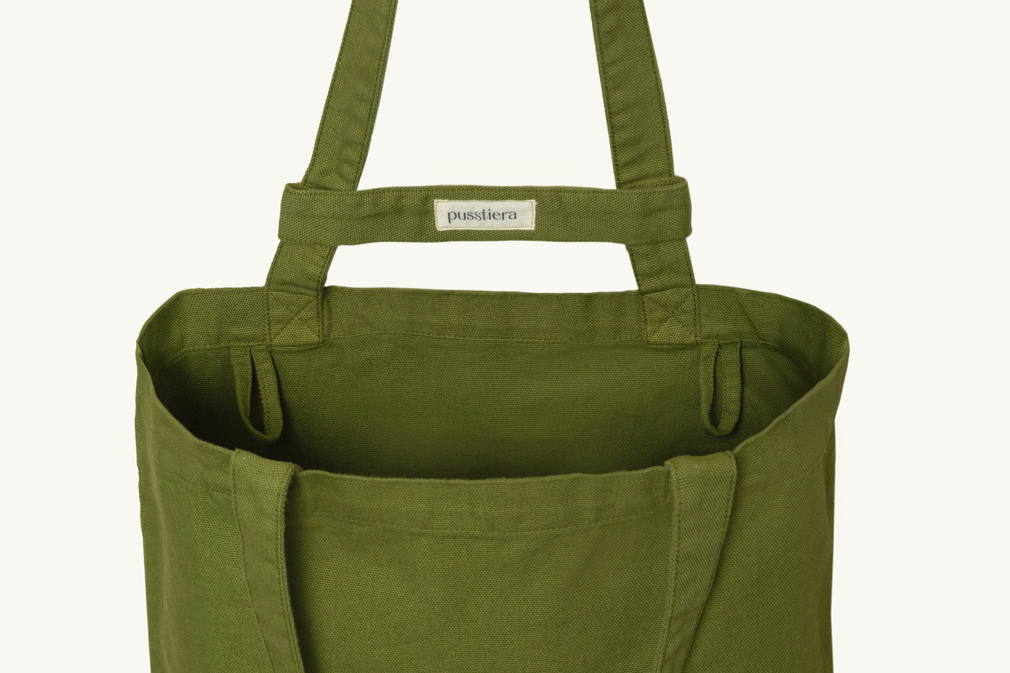 pusstiera tote bag An elegant sustainable cotton canvas tote bag, eco-friendly, premium Swedish design with Scandinavian quality, made in Europe, in limited edition numbered bags. Avocado color with four utility loops and a stabilizing strap