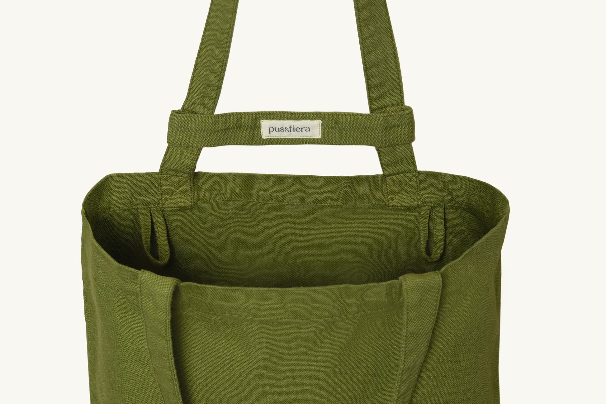 pusstiera tote bag An elegant sustainable cotton canvas tote bag, eco-friendly, premium Swedish design with Scandinavian quality, made in Europe, in limited edition numbered bags. Avocado color with four utility loops and a stabilizing strap