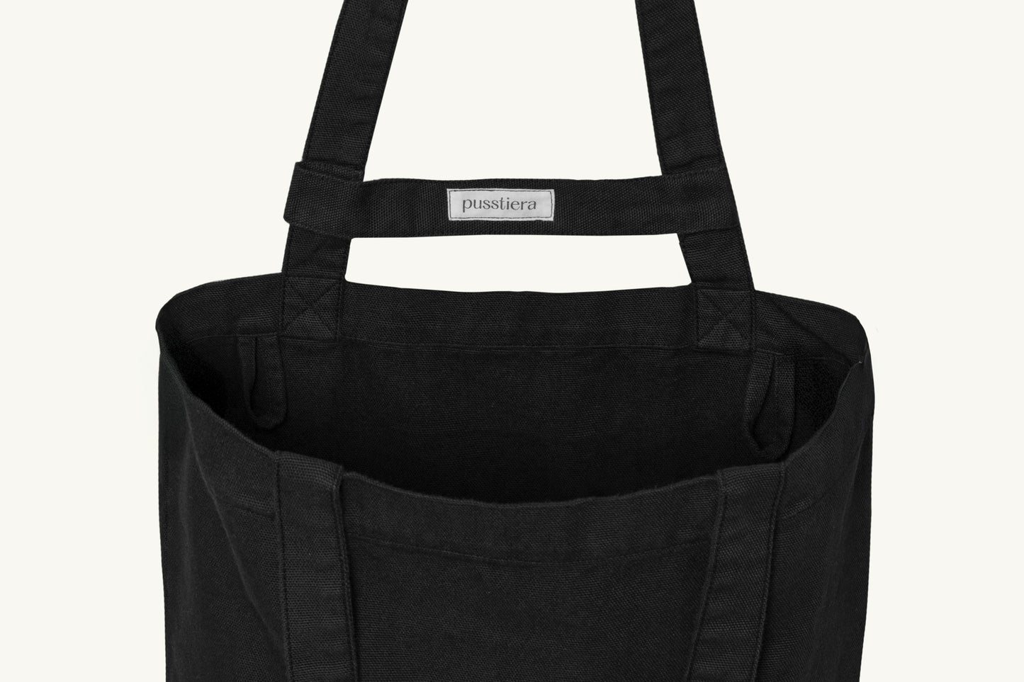 pusstiera tote bag An elegant sustainable cotton canvas tote bag, eco-friendly, premium Swedish design with Scandinavian quality, made in Europe, in limited edition numbered bags. Black caviar color with four utility loops and a stabilizing strap