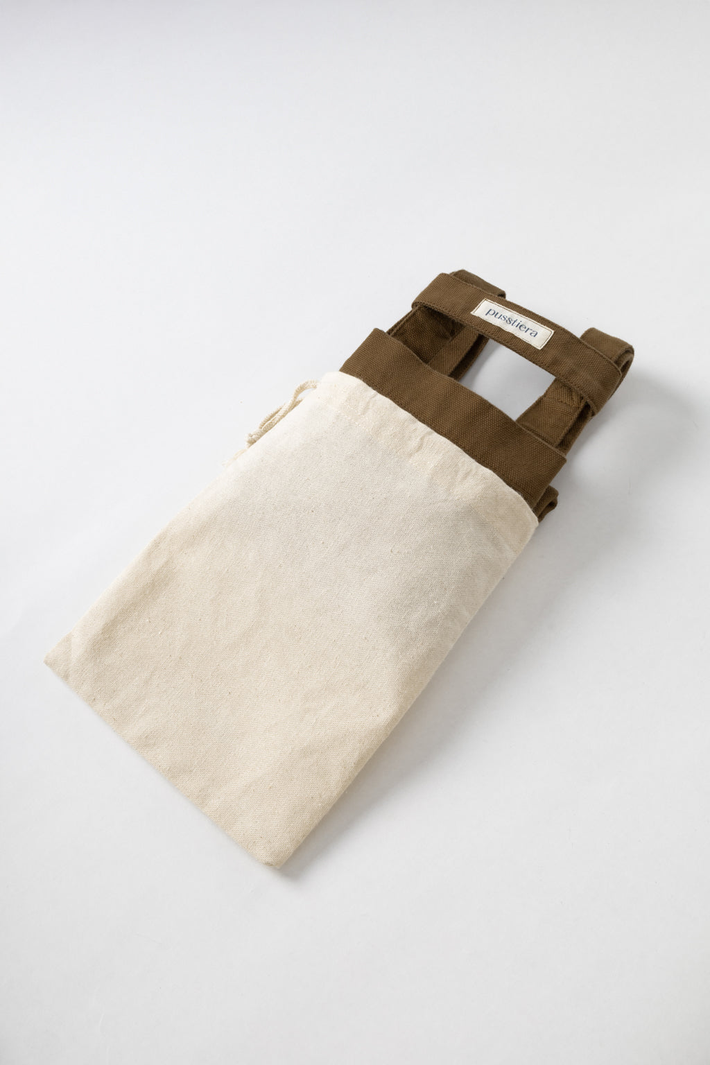 pusstiera tote bag An elegant sustainable cotton canvas tote bag, eco-friendly, premium Swedish design with Scandinavian quality, made in Europe, in limited edition numbered bags. Cappuccino color with four utility loops and a stabilizing strap