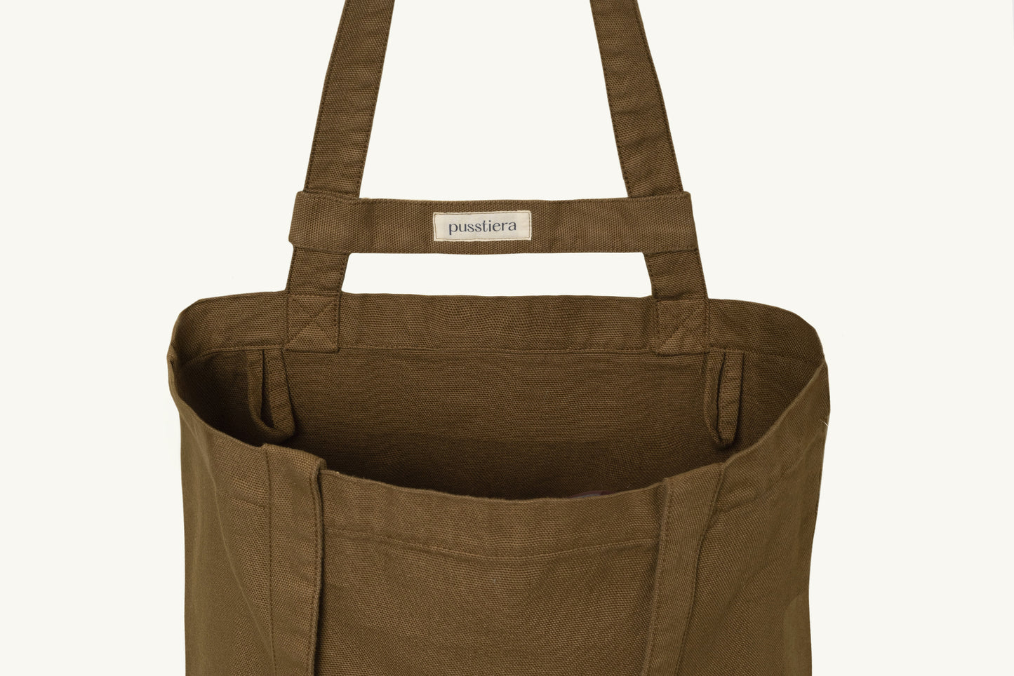 pusstiera tote bag An elegant sustainable cotton canvas tote bag, eco-friendly, premium Swedish design with Scandinavian quality, made in Europe, in limited edition numbered bags. Cappuccino color with four utility loops and a stabilizing strap