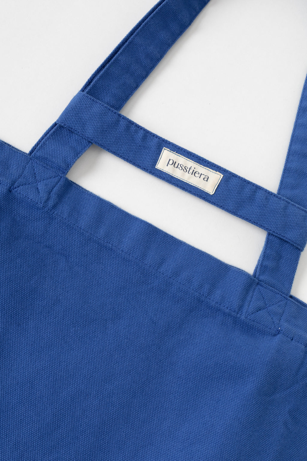 pusstiera tote bag An elegant sustainable cotton canvas tote bag, eco-friendly, premium Swedish design with Scandinavian quality, made in Europe, in limited edition numbered bags. Classic blue color with four utility loops and a stabilizing strap