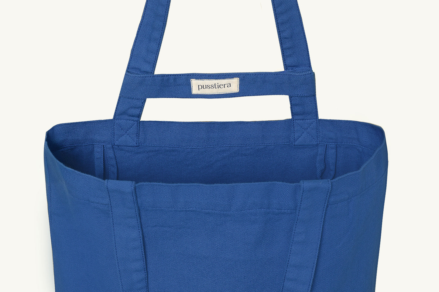 pusstiera tote bag An elegant sustainable cotton canvas tote bag, eco-friendly, premium Swedish design with Scandinavian quality, made in Europe, in limited edition numbered bags. Classic blue color with four utility loops and a stabilizing strap