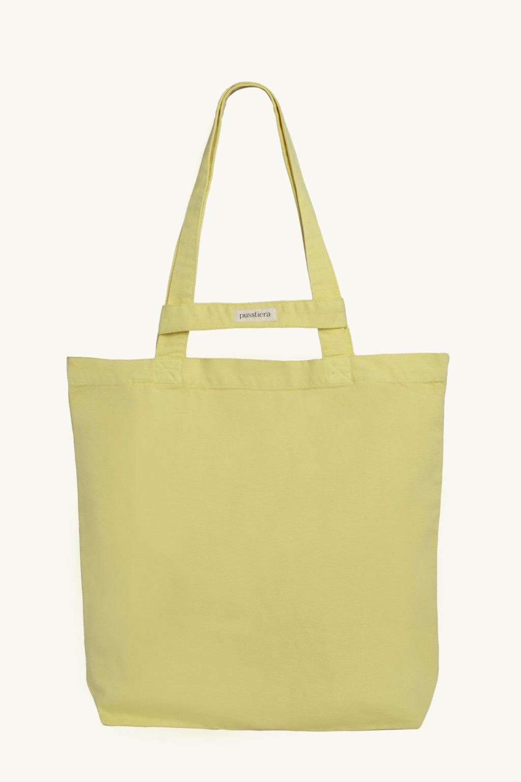 pusstiera tote bag An elegant sustainable cotton canvas tote bag, eco-friendly, premium Swedish design with Scandinavian quality, made in Europe, in limited edition numbered bags. custard lemon color with four utility loops and a stabilizing strap
