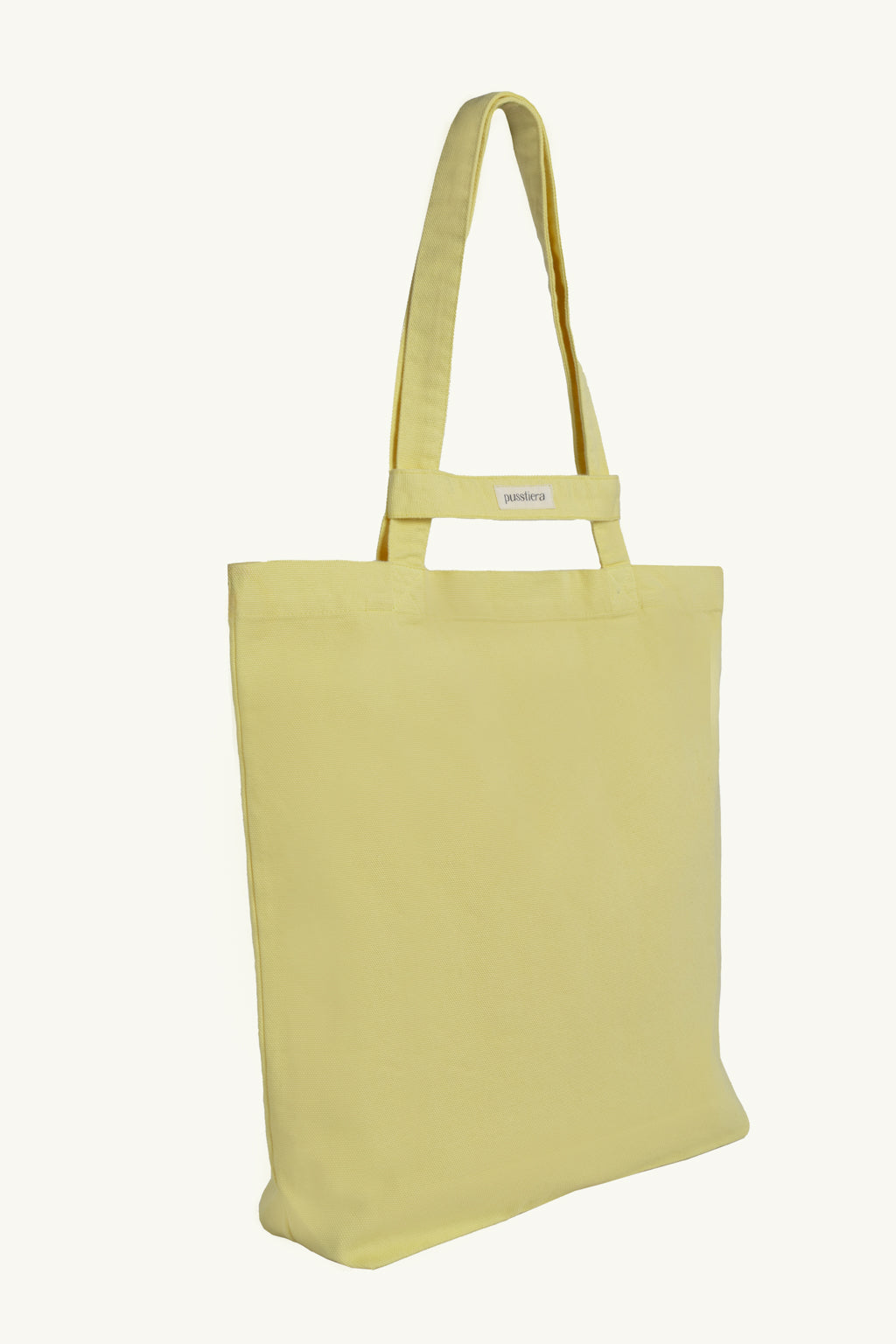 pusstiera tote bag An elegant sustainable cotton canvas tote bag, eco-friendly, premium Swedish design with Scandinavian quality, made in Europe, in limited edition numbered bags. custard lemon color with four utility loops and a stabilizing strap