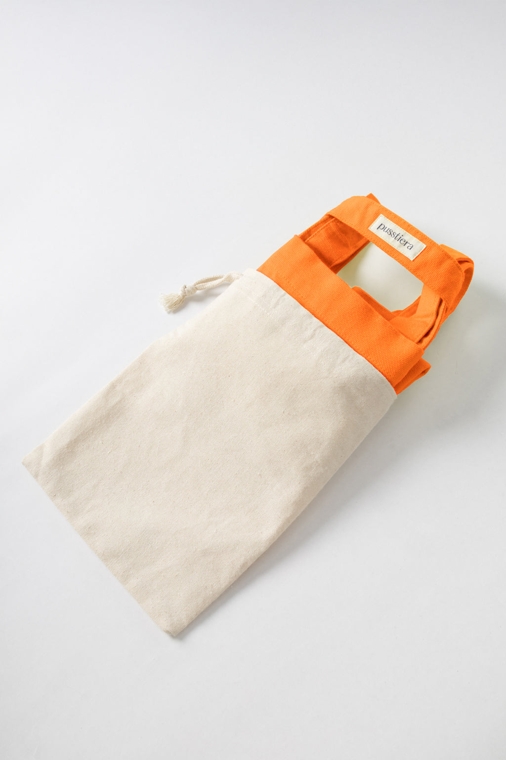 pusstiera tote bag An elegant sustainable cotton canvas tote bag, eco-friendly, premium Swedish design with Scandinavian quality, made in Europe, in limited edition numbered bags. vivid orange color with four utility loops and a stabilizing strap