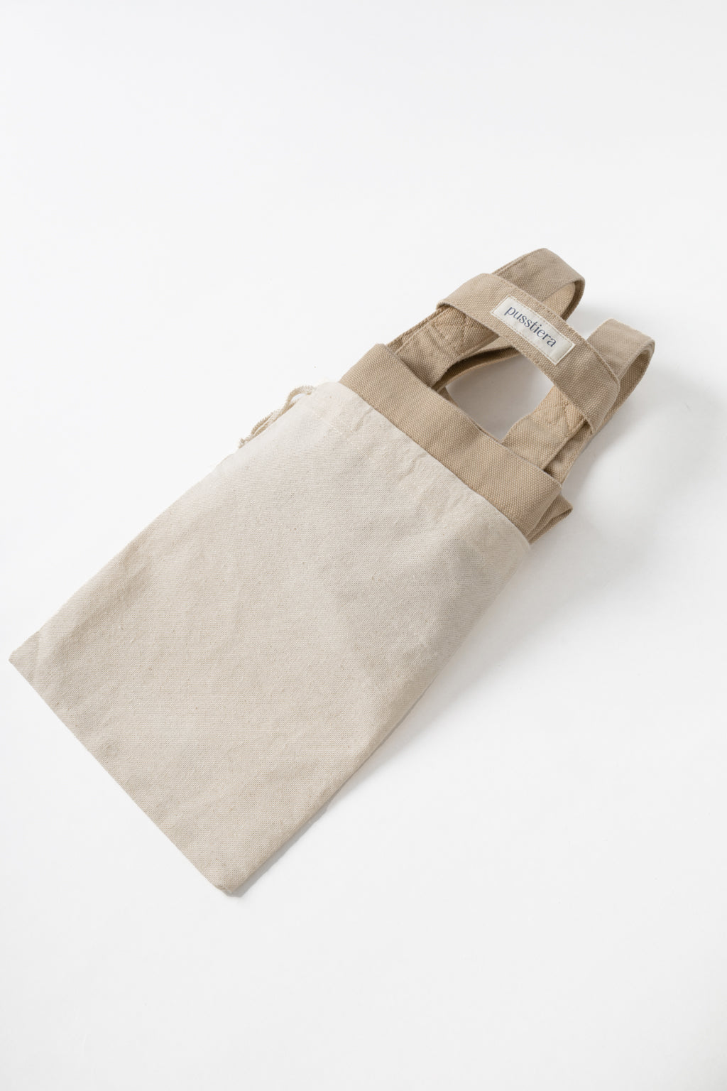 pusstiera tote bag An elegant sustainable cotton canvas tote bag, eco-friendly, premium Swedish design with Scandinavian quality, made in Europe, in limited edition numbered bags. Warm taupe color with four utility loops and a stabilizing strap