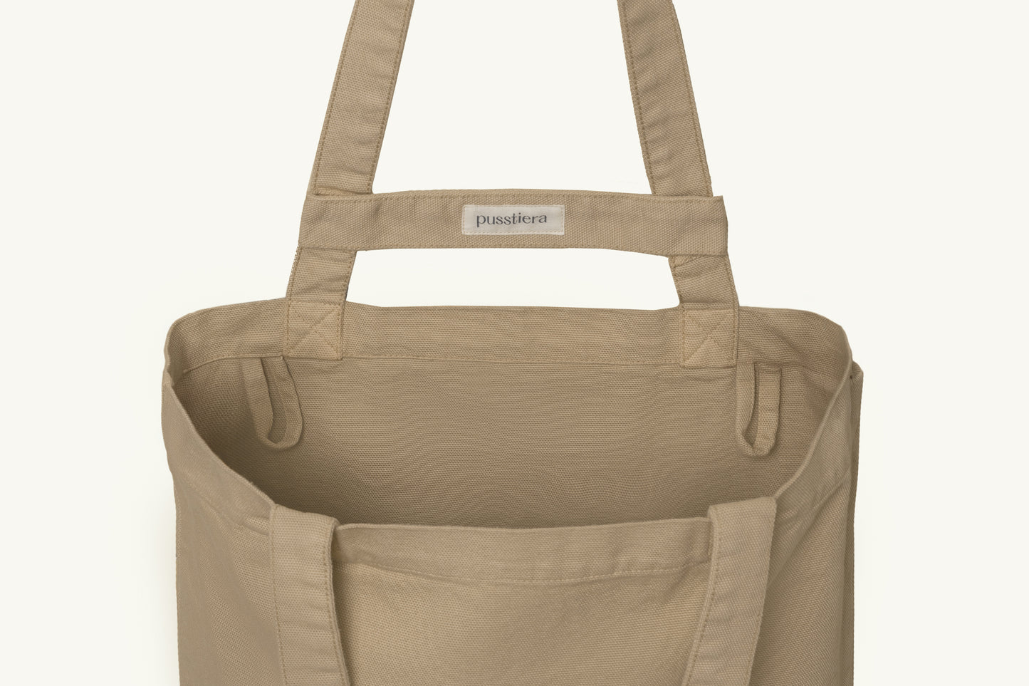 pusstiera tote bag An elegant sustainable cotton canvas tote bag, eco-friendly, premium Swedish design with Scandinavian quality, made in Europe, in limited edition numbered bags. Warm taupe color with four utility loops and a stabilizing strap