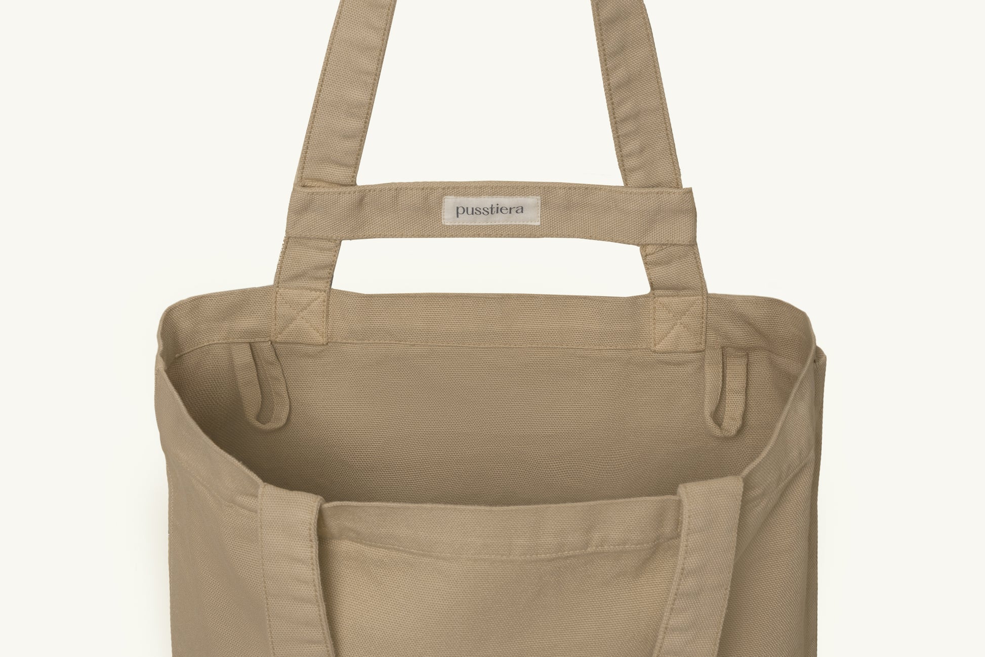 pusstiera tote bag An elegant sustainable cotton canvas tote bag, eco-friendly, premium Swedish design with Scandinavian quality, made in Europe, in limited edition numbered bags. Warm taupe color with four utility loops and a stabilizing strap
